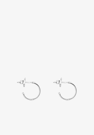 Boucles d'oreilles en argent au design minimaliste, caractérisées par une forme arrondie et un système de fixation à tige sécurisé. Surface lisse et polie.