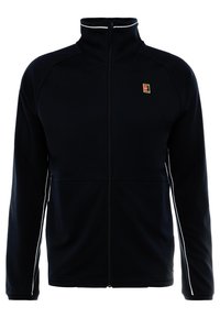Giacca nera con zip full-zip, colletto alto, bordi bianchi sulle maniche e un piccolo logo multicolore sul lato sinistro del petto.