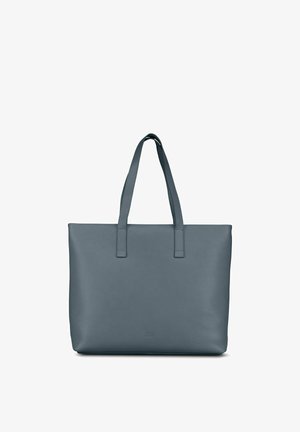 Sac fourre-tout en cuir gris avec deux bretelles d'épaule et un design lisse et minimaliste, debout sur un fond blanc.