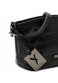 Black leather handbag with crocodile texture, silver hardware, and a detachable tag featuring a logo. Structured design with a short strap.