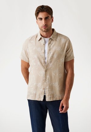 Short-sleeve, light beige shirt with a leaf design. Made of lightweight fabric, features a button-up front and a classic collar.