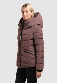 Burgundy puffer jacket with a large hood, diagonal quilted design, zip front closure, and side pockets. Features branded detailing and black accents.