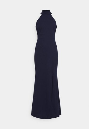 Navy halter-neck dress with a high collar, fitted bodice, and a side slit. Made from smooth fabric with a sleek, elongated silhouette.