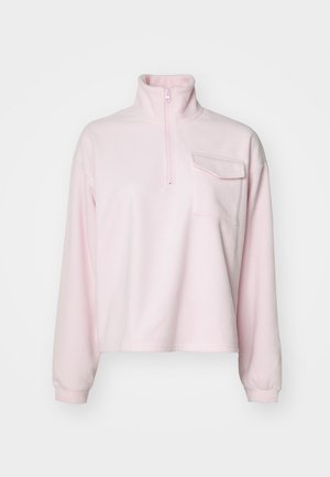Fleece pullover in soft pink, featuring a high collar, half-zip, and a chest pocket. Long sleeves with fitted cuffs. Smooth texture.