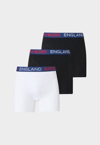 Trois paires de boxers, deux noirs et un blanc, chacun avec une ceinture bleue portant un texte rouge et blanc « BJÖRN BORG ENGLAND ».