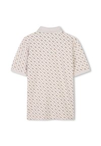 Polo à manches courtes en beige clair, présentant un motif géométrique dans des tons plus foncés, avec un col côtelé et un tissu texturé.