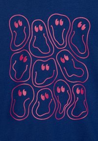 Tecido azul marinho com um padrão repetido de formas estilizadas em rosa, com rostos sorridentes e olhos grandes, criando um design divertido.