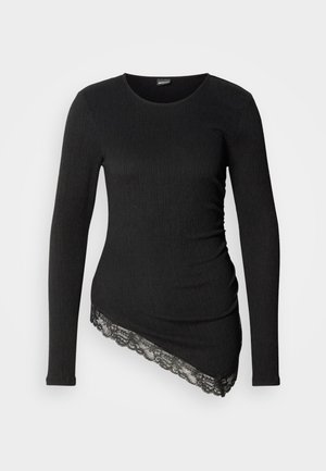 Cămașă neagră cu mâneci lungi, confecționată dintr-un material texturat, având o dantelă decorativă de-a lungul tivului asimetric.