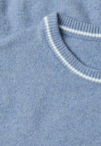 Light blue knitted sweater with a white stripe detail around the round neckline, shown close-up.