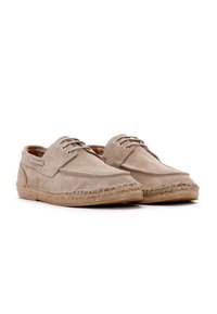 Zapatos de ante marrón claro con punta redonda, diseño de cordones y una suela intermedia de yute trenzado estilo espadrille. Textura suave y detalles de costura simples.