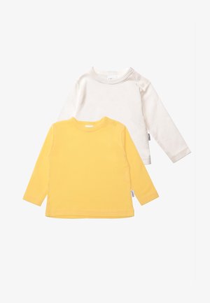 Two long-sleeve t-shirts: one creamy white with a round neckline and shoulder snaps, the other bright yellow with a smooth texture.