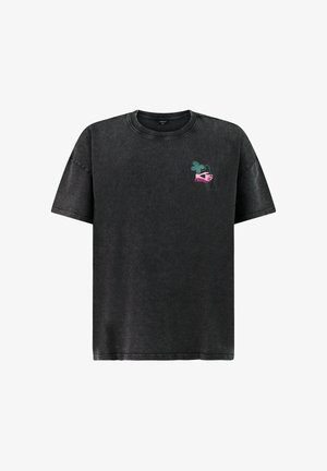 Black oversized short-sleeve t-shirt with small graphic of green clover, pink hand, and pink text "PROTECT" on left chest.