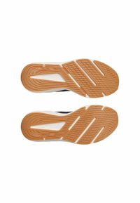 Sport shoes with a textured rubber sole featuring a combination of orange and white, designed for grip and comfort. Classic athletic design.