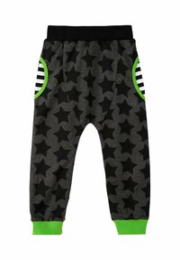 Pantaloni della tuta neri con motivo a stelle, realizzati in morbido materiale, con dettagli in verde e tasche a strisce. Vita e polsini elasticizzati.
