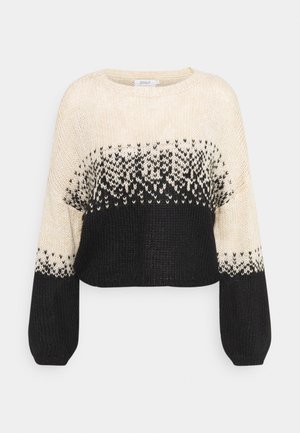 Neulepaita, jossa on pyöreä kaula-aukko, musta ja kerma väri-ero sekä geometrinen kuvio, joka on kudottu taidokkaasti suunnitteluun.