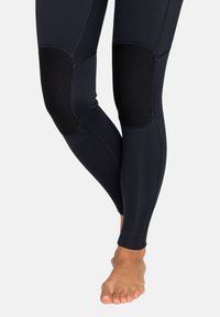 Marineblauwe leggings van rekbaar materiaal met zwarte, gestructureerde kniepatches en platte naden. Ontworpen voor comfort en beweging.