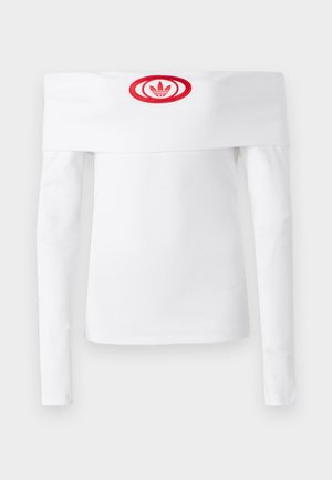 White long-sleeve off-the-shoulder shirt, ribbed texture, features a red circular Adidas logo on the front center.