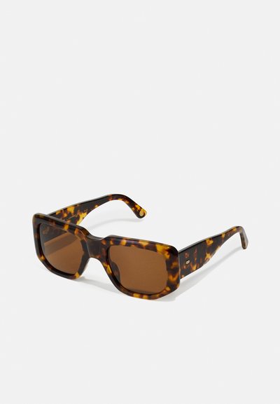 Tortoiseshell sunglasses with a square frame, gradient brown lenses, wide temples, and a glossy finish. No visible logos or hardware details.
