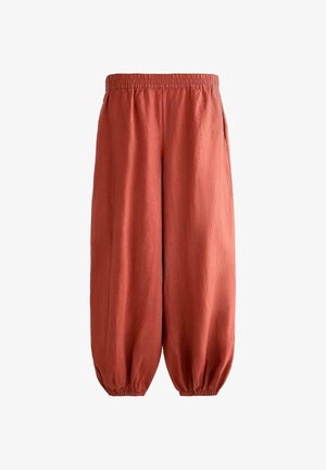 Pantalon ample en lin couleur rouille avec taille élastique et poignets élastiques froncés, doté de poches latérales.