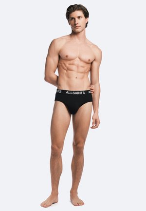 Black cotton briefs with a white "ALLSAINTS" logo on the waistband, featuring a snug fit and smooth texture. Model displays body shape.