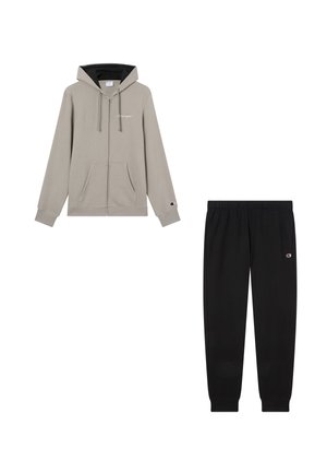 Light gray zip-up hoodie with front pockets and black drawstring lining, paired with black elastic-waist sweatpants, both featuring small logos.