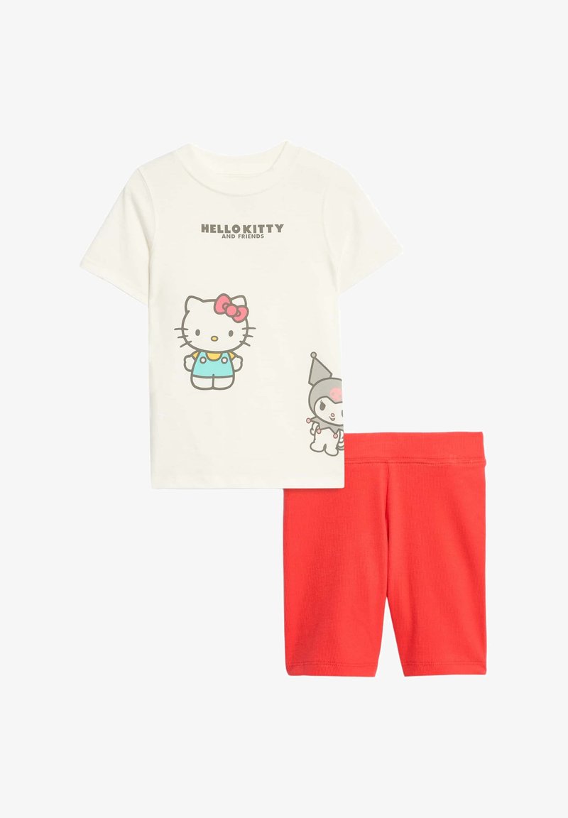 Bavlněný dvoudílný set obsahující krémové tričko s grafikou Hello Kitty a šortky s elastickým pasem v červené barvě. Hladká textura a volný střih.