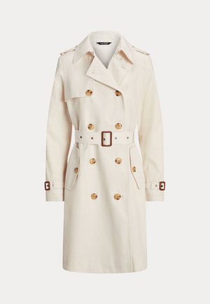Trench-coat croisé couleur crème avec boutons marron, taille ceinturée, épaulettes et brides aux poignets des manches longues.