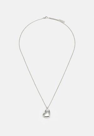 Silver necklace featuring a heart-shaped pendant, textured surface, and a fine chain with a clasp. Pendant includes a clear engraved detail.