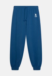 Pantaloni in cotone blu con cintura elastica e cordino. Le coppe sono aderenti alle caviglie. Presentano un logo bianco sul lato.