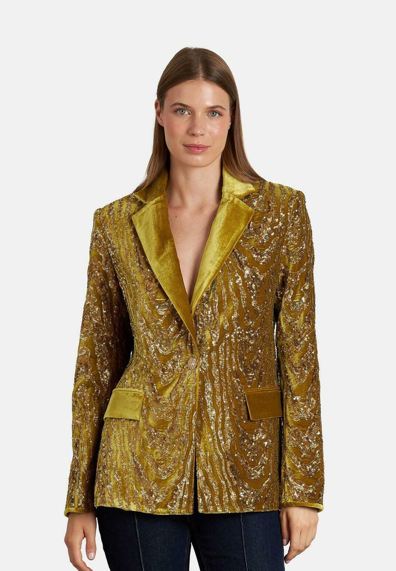 Velours blazer in mosterdgeel met ingewikkelde paillettenpatronen, gestructureerde kraag en twee voorzakken. Gestructureerde stof en tailored fit.