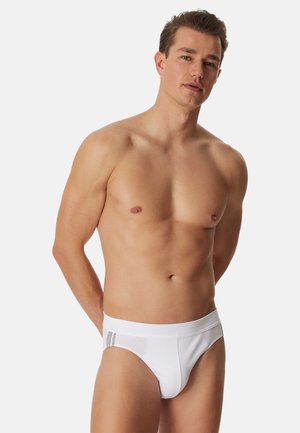 Slip da uomo bianchi con fascia elastica morbida, caratterizzata da un dettaglio grigio. Progettati per il comfort, realizzati con un tessuto liscio.