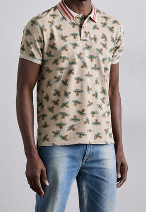 Short-sleeve, beige polo shirt with a pattern of colorful spaceships and flowers, featuring a red-striped collar and a soft texture.