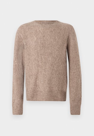 Vaaleanruskea neulottu neule, jossa on hillitty chevron-kuvio, pyöreä pääntie, pitkät hihat sekä ribbireunat hihansuissa ja helmassa.