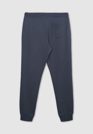 Granatowe dresy z miękkiego materiału posiadają elastyczny pasek w talii, ściągacze u kostek oraz jedną tylną kieszeń. Gładka tekstura i prosty design.