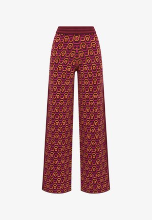 Pantaloni a gamba larga realizzati in tessuto lavorato a maglia con un motivo esagonale nei colori rosa, arancione e marrone. La cintura è a coste per garantire comfort.