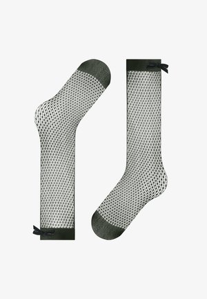 Czarne skarpetki siateczkowe z wzorem w rybnią sieć, z solidnym palcem i akcentem w postaci kokardy na górze w stylu sięgającym do kolan.