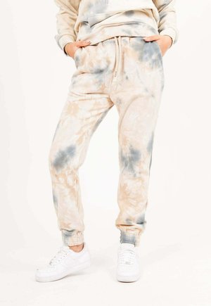 TIE DYE - Tracksuit bottoms - beige