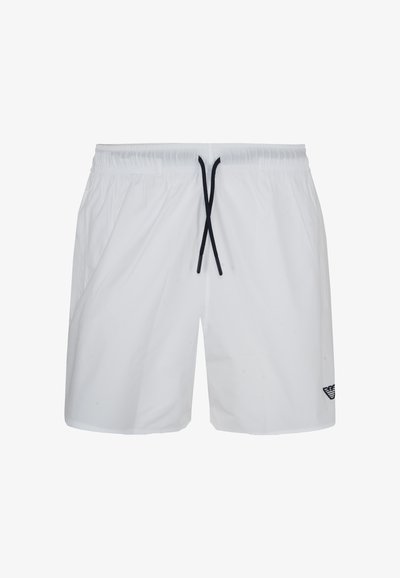 Short de bain blanc pour homme avec ceinture élastique, cordon noir et petit logo noir sur la partie inférieure gauche de la jambe.
