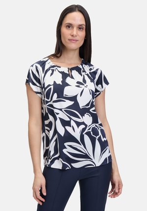 Marinebluse mit weißem Blumenmuster, kurzen Ärmeln und einem Ausschnitt mit Schlüsselhole-Detail. Hergestellt aus glattem, leichtem Stoff.