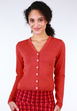 Red knit cardigan with a V-neck and diamond pattern across the shoulders. Features buttons down the front and ribbed cuffs.