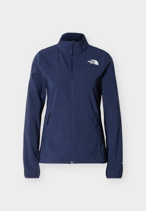 Sieviešu tumši zila jaka ar rāvējslēdzēju, augstu apkakli, garām piedurknēm, sānu rāvējslēdzēja kabatām un The North Face logotipu uz krūtīm.