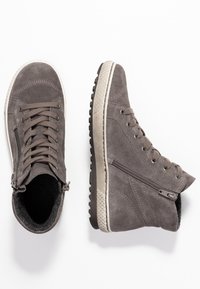 Pair of gray suede high-top sneakers with laces, side zippers, and textured white rubber soles on a white background.