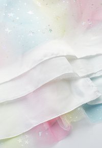 Multicolored sheer fabric, transitioning from pale pink to blue, layered with a white satin edge, featuring sparkly star patterns.