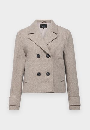 Beige kaksirivinen villableiser leveillä kauluksilla, neljällä mustalla napilla, pitkät hihat ja kaksi etutaskua.