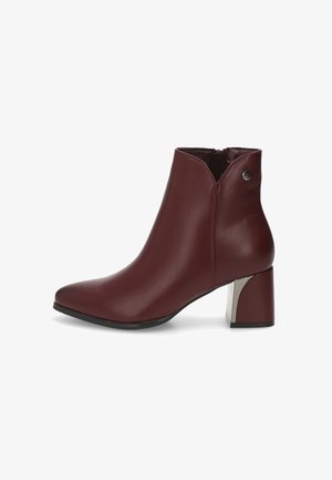 Botines de cuero burdeos con puntera afilada, cremallera lateral y un tacón bloque metálico con un diseño curvado y detalle de logo.