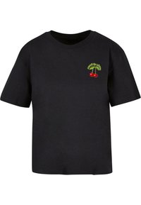 Sort bomulds T-shirt med korte ærmer, forsynet med en broderet grafik af kirsebær og "Kings of Leon" i grøn ovenfor designet.