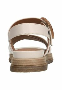 White leather back-strap sandal with a round buckle, tan insole, and a textured brown sole. Features a layered cork-like heel design.