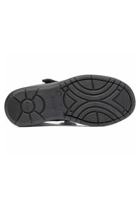 Suela de zapato de goma negra con patrones texturizados, que incluyen ranuras y grips para tracción, y el nombre de la marca "Goru" grabado.