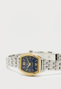 Rectangular wristwatch with gold bezel, blue dial, silver metal link band, Roman numerals, and gold hands showing 2:55.