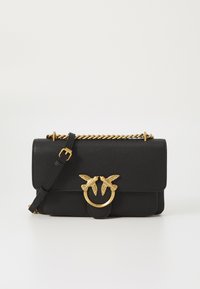 Black textured leather handbag with gold-tone hardware, featuring a circular clasp adorned with two bird motifs and a chain strap.